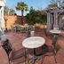 Aerie Bed & Breakfast in New Bern: brick patio with tables, chairs, and a pergola-covered seating area