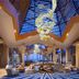 Mulia Resort, South Kuta: grand lobby with sculptural chandelier, vaulted skylight and ocean view