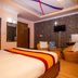 OYO 11457 Kathmandu Resort Hotel room in Kathmandu with bed, wicker chair, TV and wood flooring
