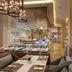 Mulia Resort, South Kuta: elegant restaurant interior with chandeliers, dining tables, and buffet counters