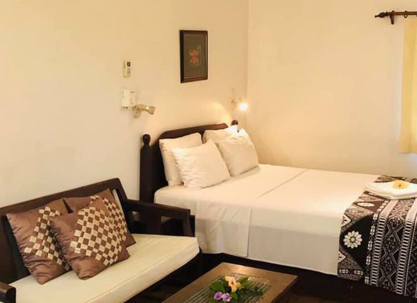 Five Princes Hotel, Suva: simple room with bed, daybed, patterned throw, and window light