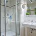 Gästehaus Enzianhof Hotel Garni bathroom in Oberammergau with glass shower and sink