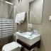 Hostal Mellizo in Lebrija bathroom with walk-in shower, sink, toilet and frosted glass enclosure