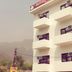 Hotel Vishla Palace in Rishikesh exterior with balconies and hillside backdrop
