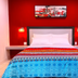 Retreat At Crystal Manatee room in Crystal River with red accent wall and colorful bedspread