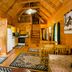 Highland Hills Motel & Cabins in Boone cabin interior with kitchen, loft stairs, and rustic wood walls