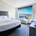 Shutters Hotel in Elko guest room with king bed and large window overlooking mountains