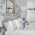 Sandway House Torquay bedroom with white bed, floral accent wall, wall mirror, and sliding closet doors