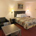 Scottish Inns Mcminnville room with bed, sofa, and table in McMinnville