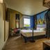 ibis Styles Toulouse-Blagnac Aéroport room in Blagnac with bed, desk, city mural and airport view