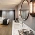 Hotel28 Myeongdong Seoul guest room with bed, marble bathroom wall, and large round mirror