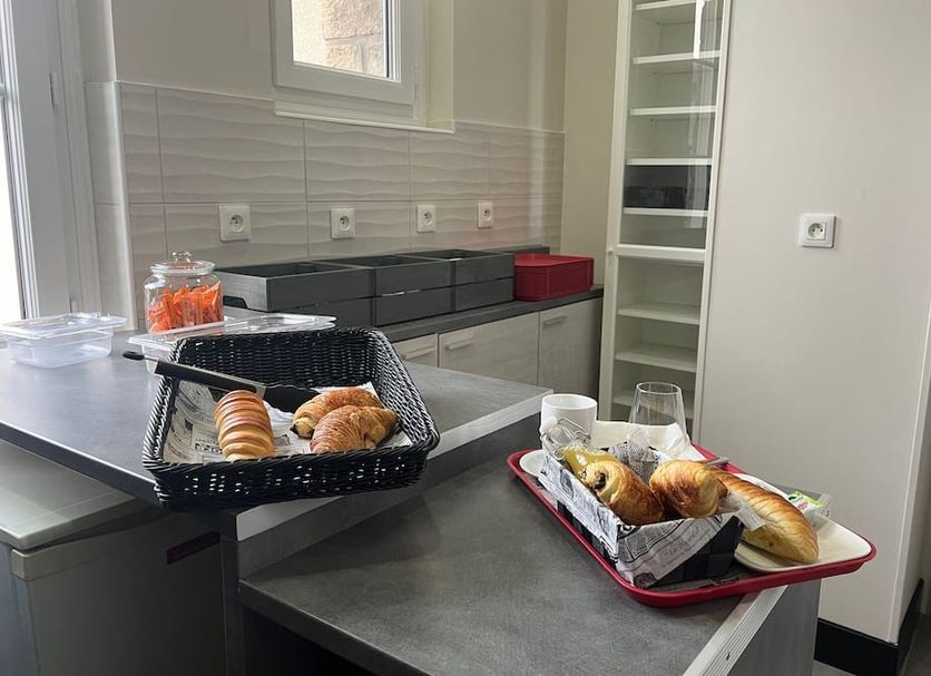Armor Hotel Compiègne breakfast display with pastries on trays and counter in a bright room