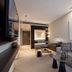Der Öschberghof in Donaueschingen: modern suite with sofa, desk, and warm ambient lighting