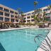 Grand Vista Hotel in Simi Valley: outdoor courtyard pool with lounge chairs and palm trees