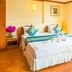Chomsin Hua Hin guest room with two twin beds, bright window, and swan towel display in Hua Hin