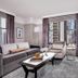 Westhouse Hotel New York suite with city view, sofa, armchair, and coffee table in New York.