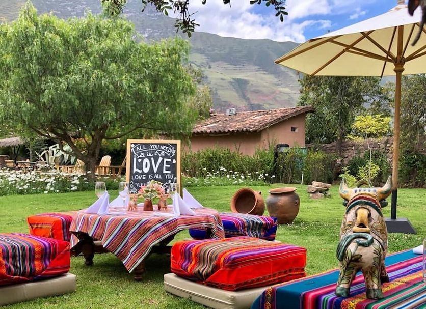 Hotel La Casona De Yucay Valle Sagrado in Yucay, outdoor garden seating with colorful pillows and mountain views