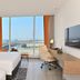 Clarion Hotel Jeddah Airport room with twin beds, desk and city view in Jeddah