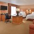 Hampton Inn & Suites Buffalo guest room with two beds, desk, chair and sitting area