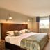 Isle Of Mull Hotel and Spa guest room with king bed, window view, and desk on the Isle of Mull