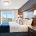 Newport Beach Hotel & Suites Middletown guest room with king bed and balcony ocean view