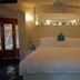 Villas Sur Mer in Negril bedroom with king bed, turquoise accents, and ceiling fan