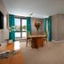 Great National South Court Hotel in Limerick guest room with bed, table, large windows and turquoise curtains