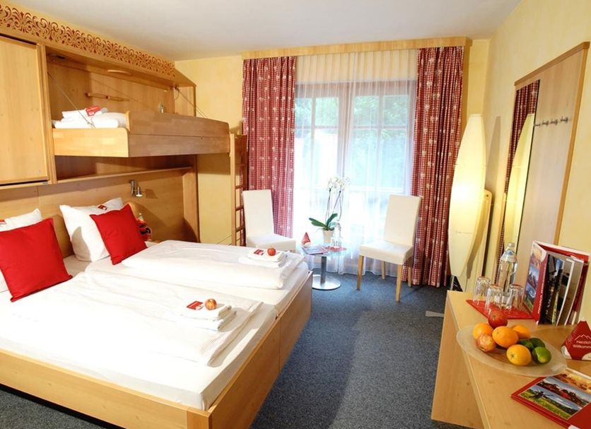 First Mountain Montafon in Gaschurn guest room with bunk bed, twin beds, window, and sitting area