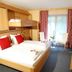 First Mountain Montafon in Gaschurn guest room with bunk bed, twin beds, window, and sitting area