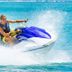 Holland House Beach Hotel in Philipsburg jet ski rider splashing across turquoise water