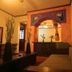 Hotel Regis Uruapan interior with lounge seating, decorative archway, and warm ambient lighting