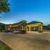 Quality Inn West Plano - Dallas exterior at dusk with entrance, parking lot, and large tree in Plano