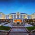 Guanyuan Liusu Hotel in Suzhou, grand hotel exterior with illuminated entrance and fountain at dusk