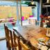Lairds Lodge Inverness dining table with flowers, pendant lights, and patio doors to outdoor seating