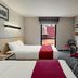 City Express by Marriott Oaxaca guest room with two beds, desk, TV, and window view