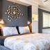 Big Bear Spa Suites in Big Bear Lake bedroom with king bed, wall art, window, and spa tub