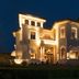 Hotel De la Ville in Riccione, illuminated at night with a grand villa-style facade