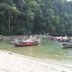 The Krabi Forest Homestay in Ao Nang with long-tail boats on a calm river beside a forested shore