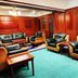 Jinshan Hotel Shanghai lounge with leather armchairs, sofa and wood-paneled walls