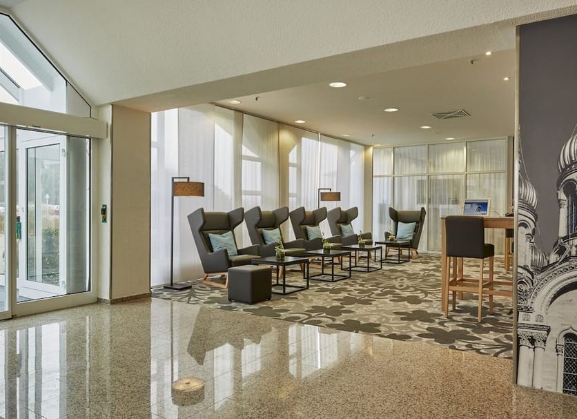H+ Hotel Wiesbaden Niedernhausen lobby lounge in Niedernhausen with seating and large windows
