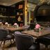 The Nikolai Hamburg - Leonardo Limited Edition lounge with tables, velvet chairs and wall-mounted TV in Hamburg