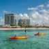Margaritaville Beach Resort Grand Cayman in George Town with beachfront towers and kayakers on turquoise water