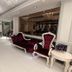 White Fort Hotel Dubai lobby with ornate red velvet seating and chandeliers
