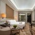 Pearl River Garden Hotel Changsha guest room with king bed, desk, seating area and city view