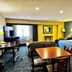 Regency Inn & Suites New London Mystic room with bed, seating area, desk and TV in New London