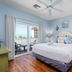 Harbour House At The Inn bedroom in Fort Myers Beach with balcony view and twin lamps