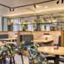 Premier Inn Glasgow - Cambuslang/M74 J2a dining area with round tables, booth seating and tropical-print chairs