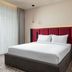 Mercure Chisinau Center Jazz Hotel in Chisinau guest room with king bed and floor-to-ceiling curtains