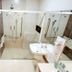 Hotel Giordano Mantiqueira bathroom with glass shower, wall-mounted sink and grab bars in São João da Boa Vista