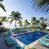 Margaritaville Island Reserve Riviera Cancun in Puerto Morelos, a poolside deck with loungers and ocean view